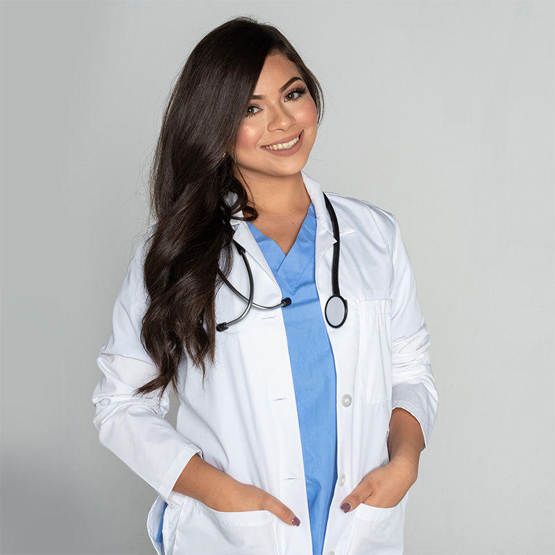 Younger female doctor wearing her white coat and a stethoscope